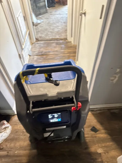 Dehumidifier operating inside an apartment unit during a Category 3 flood dry-out