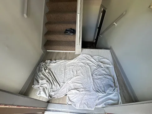 Flood water entering an apartment building through the ground-floor entryway