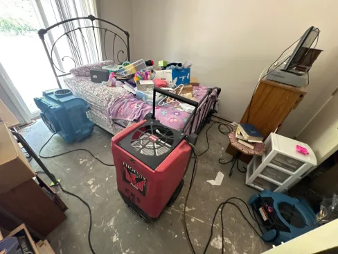 Drying equipment set in an apartment building basement affected by rising flood water