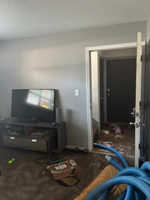 Air movers and dehumidifiers running inside a flooded Kansas City apartment during structural drying