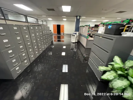 Pooled water on commercial office flooring before extraction began at the Olathe job site